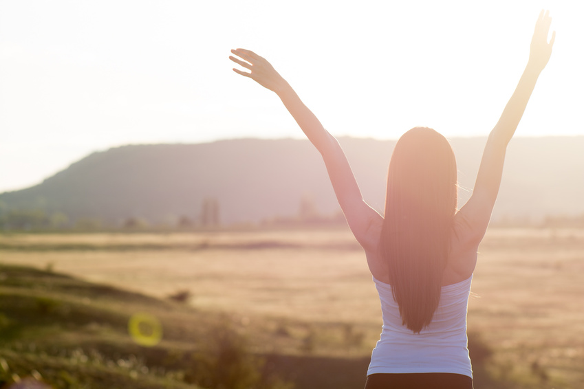 happiness - cheering woman open arms to sunrise